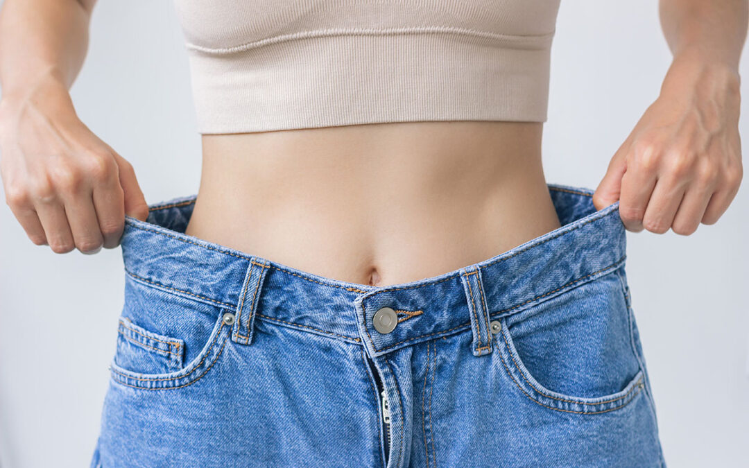A young woman tries on jeans after a healthy weight loss